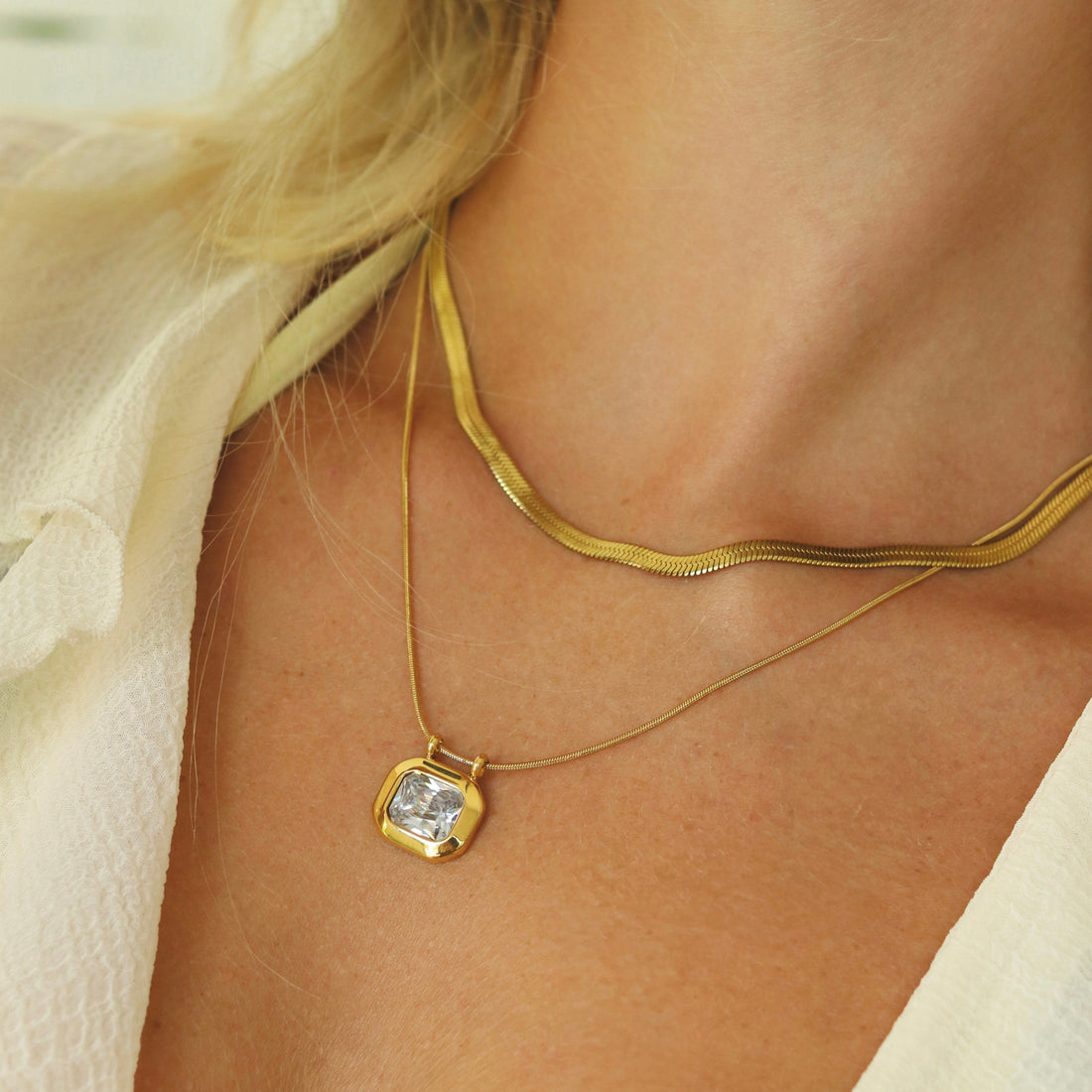 Jeune femme portant un collier à pendentif solitaire doré en acier inoxydable 304, idée cadeau de naissance Rélia Bijoux
